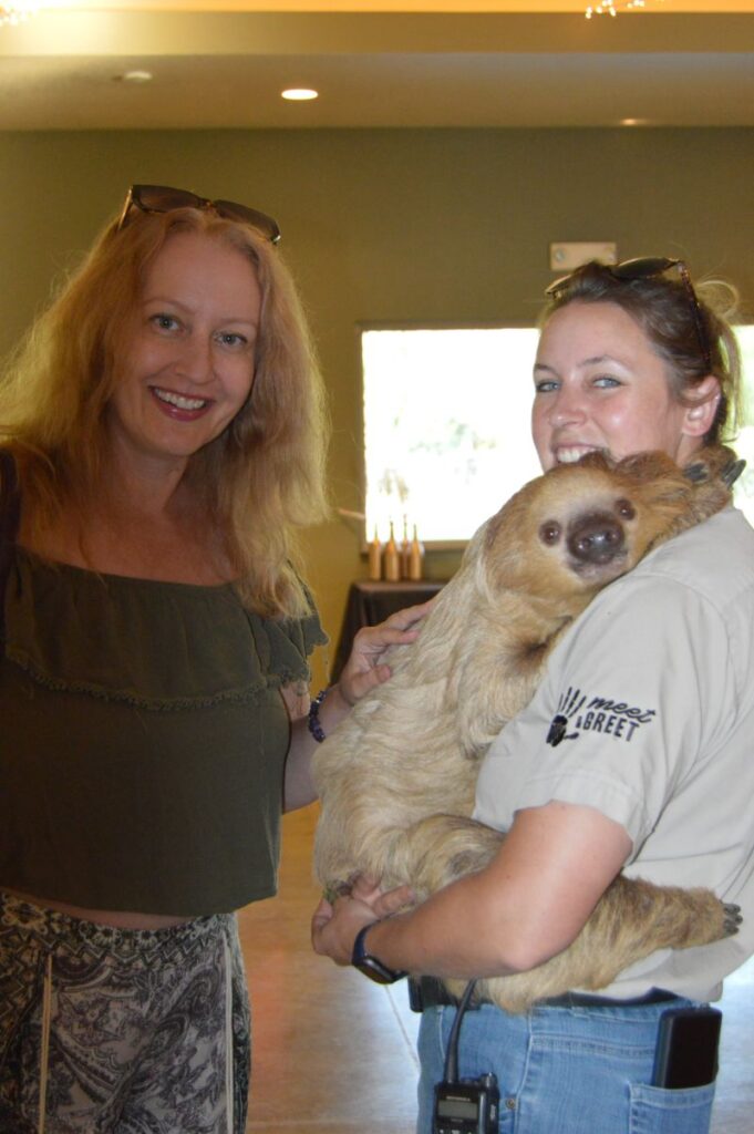 Cassie Hepler pets a sloth at Tanganyika Wildlife Park.